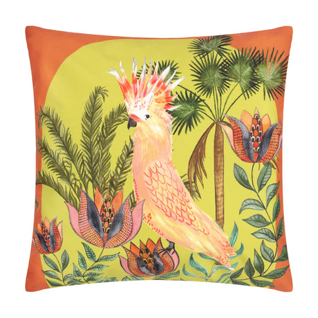 Square polyester cushion with a hand-painted cockatoo among palm fronds and tropical flowers on a lime-green ground, framed by an orange border, shown on a plain white background.