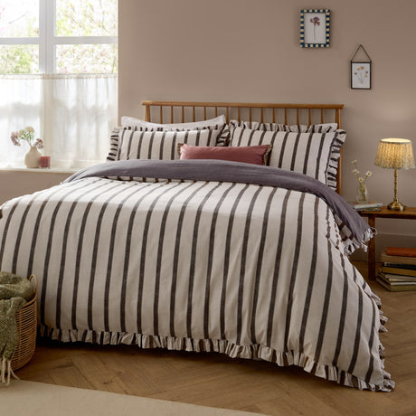 Connie Linen Plain Duvet Cover Set in chocolate, cream and brown woven stripe with ruffle-trimmed edges, shown styled on a bed with matching pillowcases in a bedroom setting.