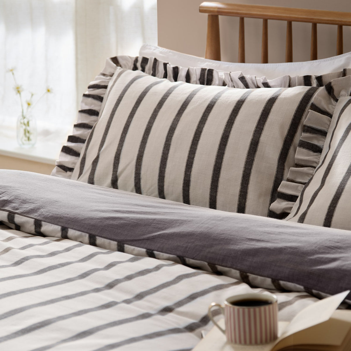 Connie Linen Plain Duvet Cover Set in Chocolate, striped cream and dark brown design with ruffle-trimmed pillowcases, shown styled on a bed in a bedroom setting.