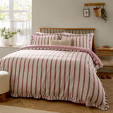 Connie Linen Duvet Cover Set in Clay Pink, reversible cream and pink striped cotton-blend bedding with ruffle trim edge, shown styled on a bed in a bedroom setting.