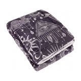 Folded Constellation Printed Polyester Throw in charcoal with cream celestial line-work of suns, moons, stars and eyes, sherpa reverse visible, on a white background.