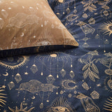 Constellation Printed Reversible Duvet Cover Set in gold and navy, showing celestial moon, sun and crystal motifs on the navy duvet and gold pillowcase.