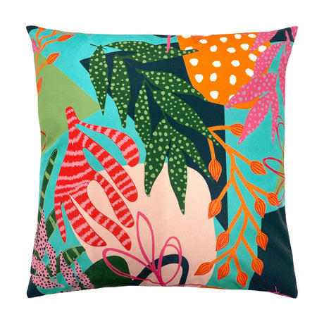 Square Coralina Abstract Polyester Cushion in Multi, featuring a bold tropical print of green leaves, red-pink fronds and orange seed pods on turquoise, coral and navy.
