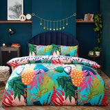 Coralina Jungle Floral Duvet Cover Set in multicoloured tropical print with pink, orange, green and navy leaves, shown on a bed with matching pillowcases in a dark teal bedroom.