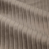 Close-up of Corinthian velvet eyelet curtain fabric in taupe, showing fine vertical micro-pleats that create a soft, light-catching ridged texture.