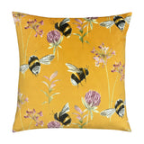 Square velvet cushion in honey yellow, 43 x 43cm, with a hand-painted bumblebee, clover and floral print, shown on a plain white background.