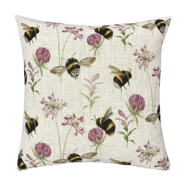 Square 43 x 43cm linen-look cushion printed with bumblebees in flight among pink clover heads and green flowering stems on a cream ground, shown against a plain white background.