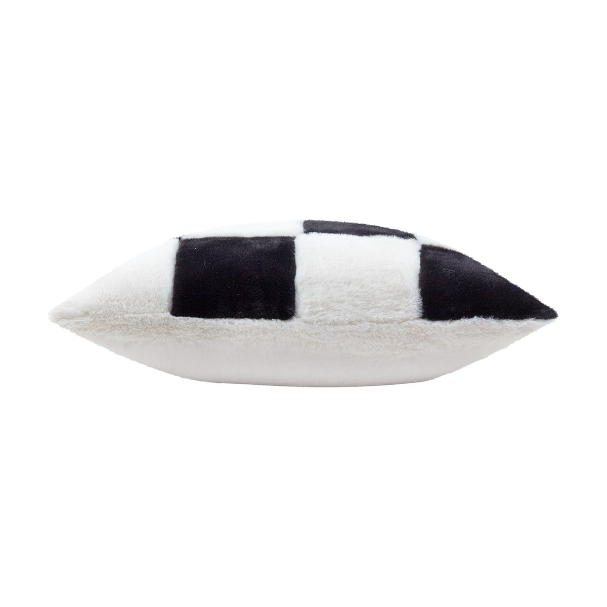 Side view of the Cozee Check faux fur cushion in black and white, showing the plump pointed edge with an oversized checkerboard pattern on one face and plain white fur on the other.