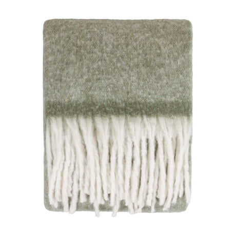 Cosy Plain Polyester Throw in Green, folded to show a soft sage woven body with knotted ivory fringe trim, shown on a plain white background.