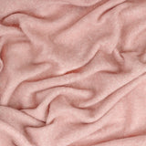 Close-up of the Cosy Plain Polyester Throw in pink, showing its soft, brushed woven texture with loosely draped folds.