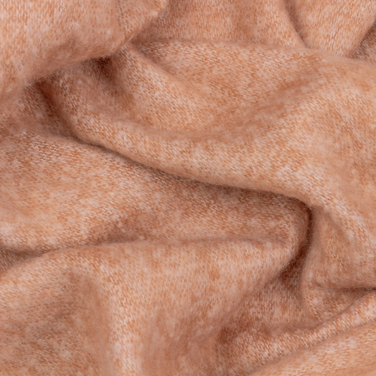 Close-up of the Cosy Plain Polyester Throw in Rust, showing the soft, textured woven fabric in a warm rust and cream heathered tone, draped and folded.