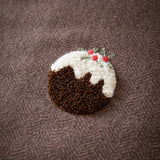 Christmas Pudding Tufted Brushed Duvet Cover Set in chocolate-brown, close-up of a raised loop-tufted pudding motif with white icing and red-green sprig detail on herringbone cotton fabric.