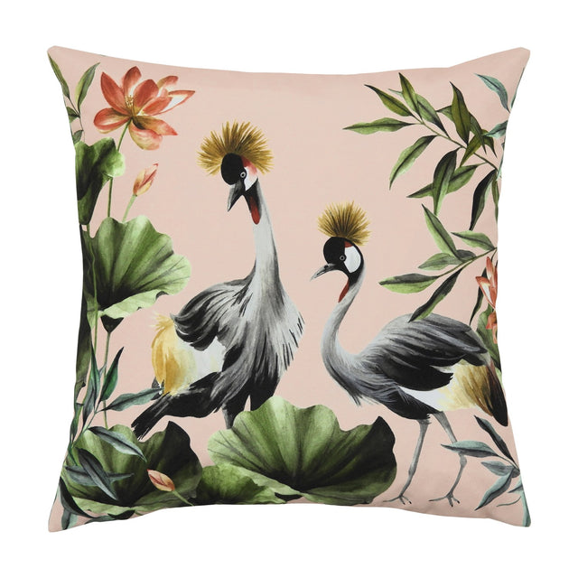 Square polyester cushion in blush pink with two crowned crane birds, tropical leaves and lotus flowers, shown on a plain white background.