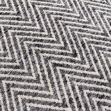 Close-up of the Croft cushion's woven front, showing a raised charcoal and cream chevron pattern in a textured twill weave.