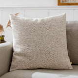 Croft Plain Velvet Cushion in natural oatmeal chevron twill, 50 x 50cm, shown on a beige sofa in a living room setting.