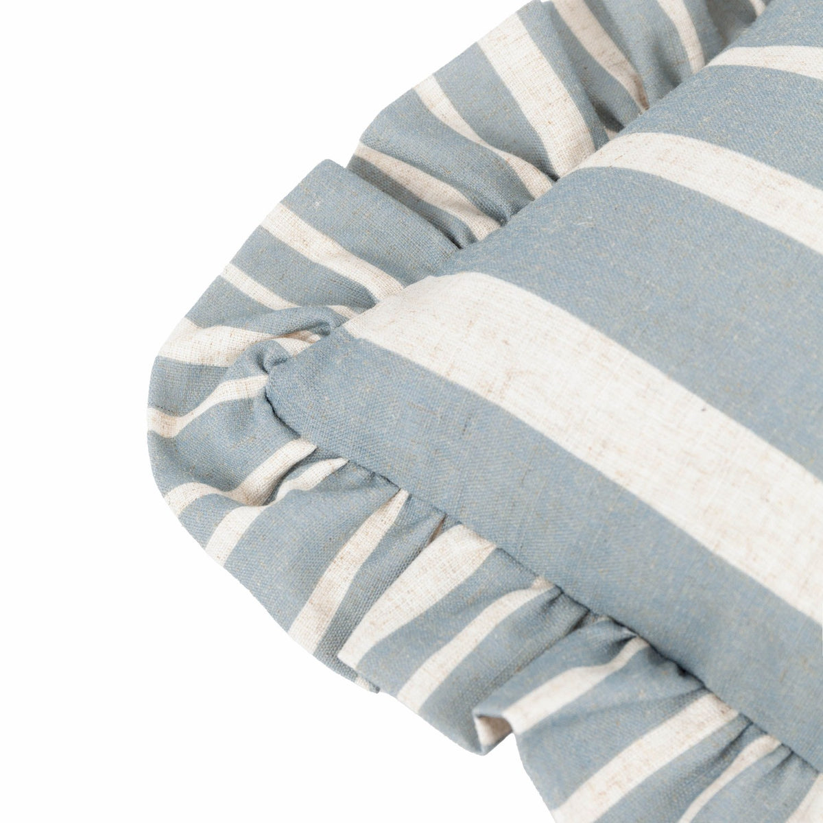 Close-up of the Carmon Stripe linen cushion corner, showing blue and cream vertical stripes with a gathered ruffle trim edge on a white background.