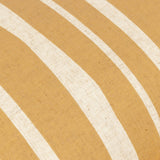 Close-up of the Carmon Stripe cushion's linen fabric in ochre, showing cream vertical stripes with a hand-drawn, slightly wavering texture.