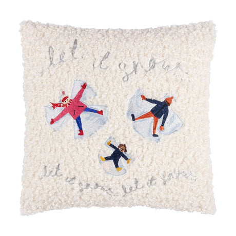 Square cream boucle fleece cushion embroidered with three figures making snow angels and "let it snow" in silver thread, on a plain white background.