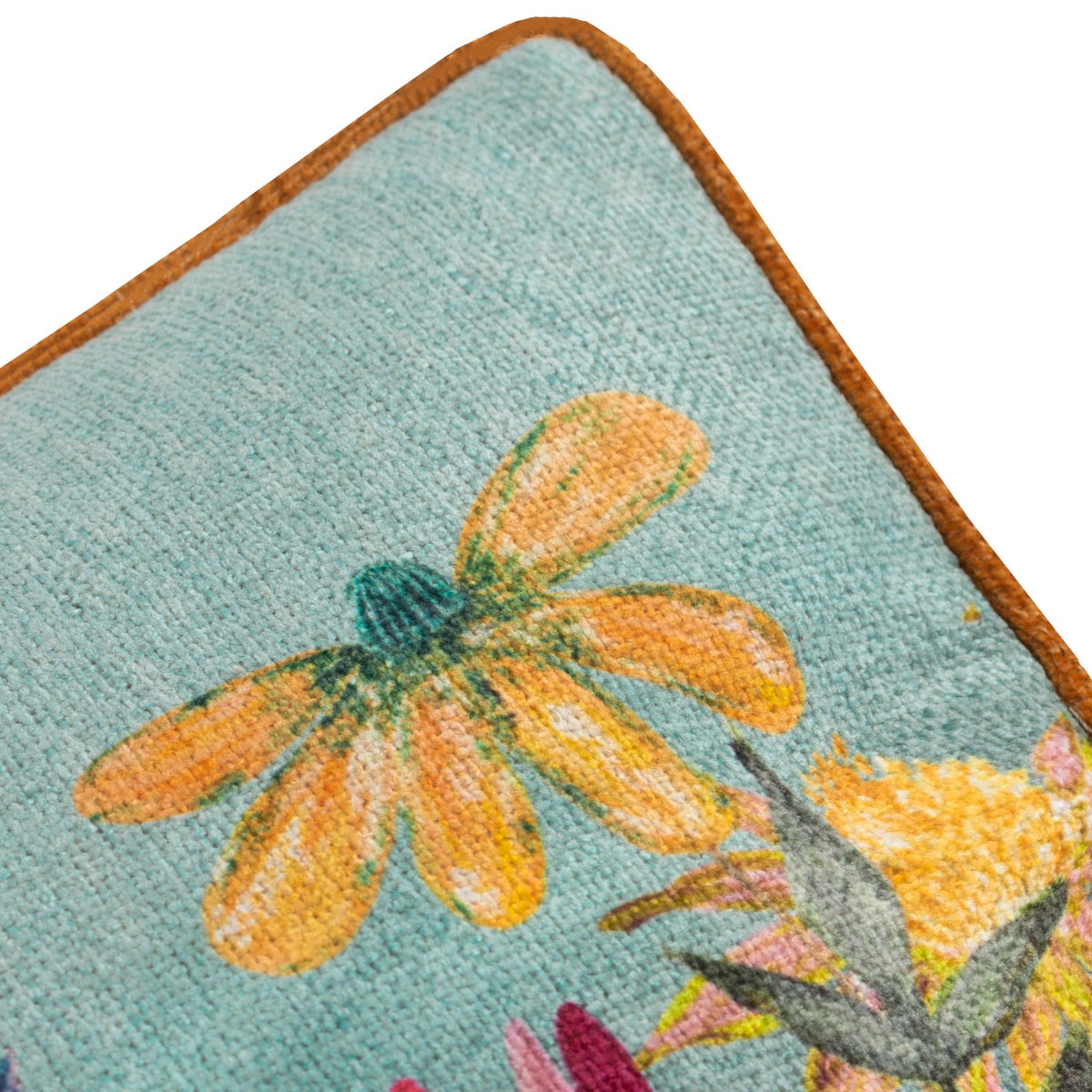 Close-up of the Country Wilds Blossom Meadow cushion corner, showing a hand-painted orange daisy on sky-blue polyester fabric with a rust-coloured piped edge.