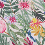 Close-up of the Country Wilds Blossom cushion's woven polyester fabric, showing pink and yellow flowers, red blooms and green foliage on a cream ground.