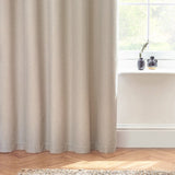 Dawn Linen Reversible Eyelet Curtains in natural marl-effect fabric, shown draped by a window with herringbone flooring and dark vases on the sill.