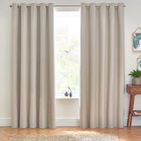 Dawn Linen Reversible Eyelet Curtains in natural linen fabric with grommet top, hung floor-length either side of a window in a living room setting.