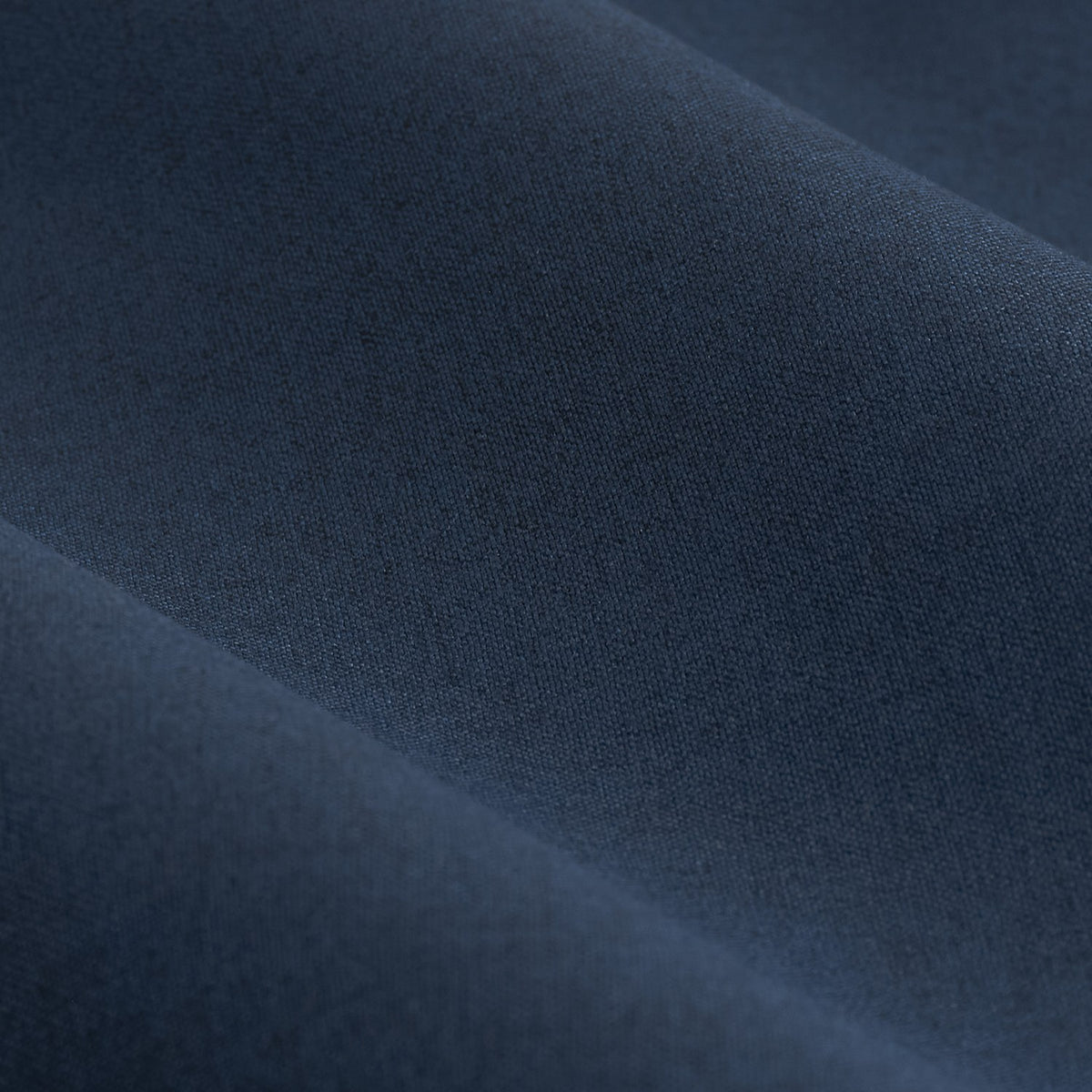 Close-up of the Dawn Plain Lined Eyelet Curtains in midnight blue, showing the soft, lightly textured polyester fabric with a smooth woven finish and gentle fold drape.