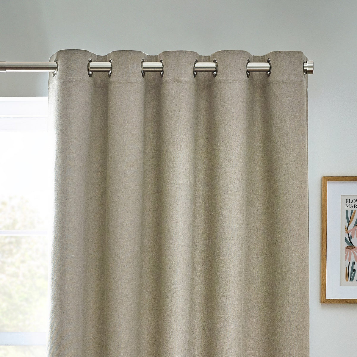Dawn Plain Reversible Eyelet Curtains in natural marl fabric with brushed metal eyelet rings, shown hanging from a pole in a room setting.