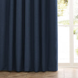 Dawn Pencil Pleat Curtains in midnight blue polyester with a soft marl-textured weave, shown hanging beside a glass door with wooden flooring.