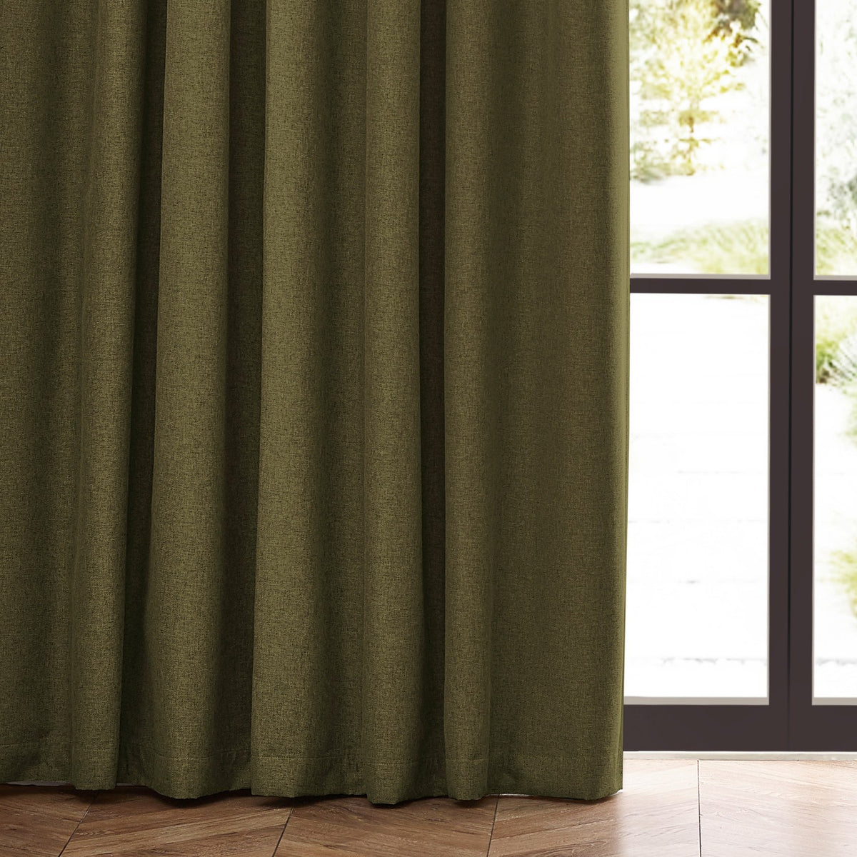 Dawn Plain Polyester Pencil Pleat Curtains in olive, showing textured marl fabric with pencil pleat heading hung beside a glass door in a living room.