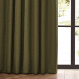 Dawn Plain Polyester Pencil Pleat Curtains in olive, showing textured marl fabric with pencil pleat heading hung beside a glass door in a living room.