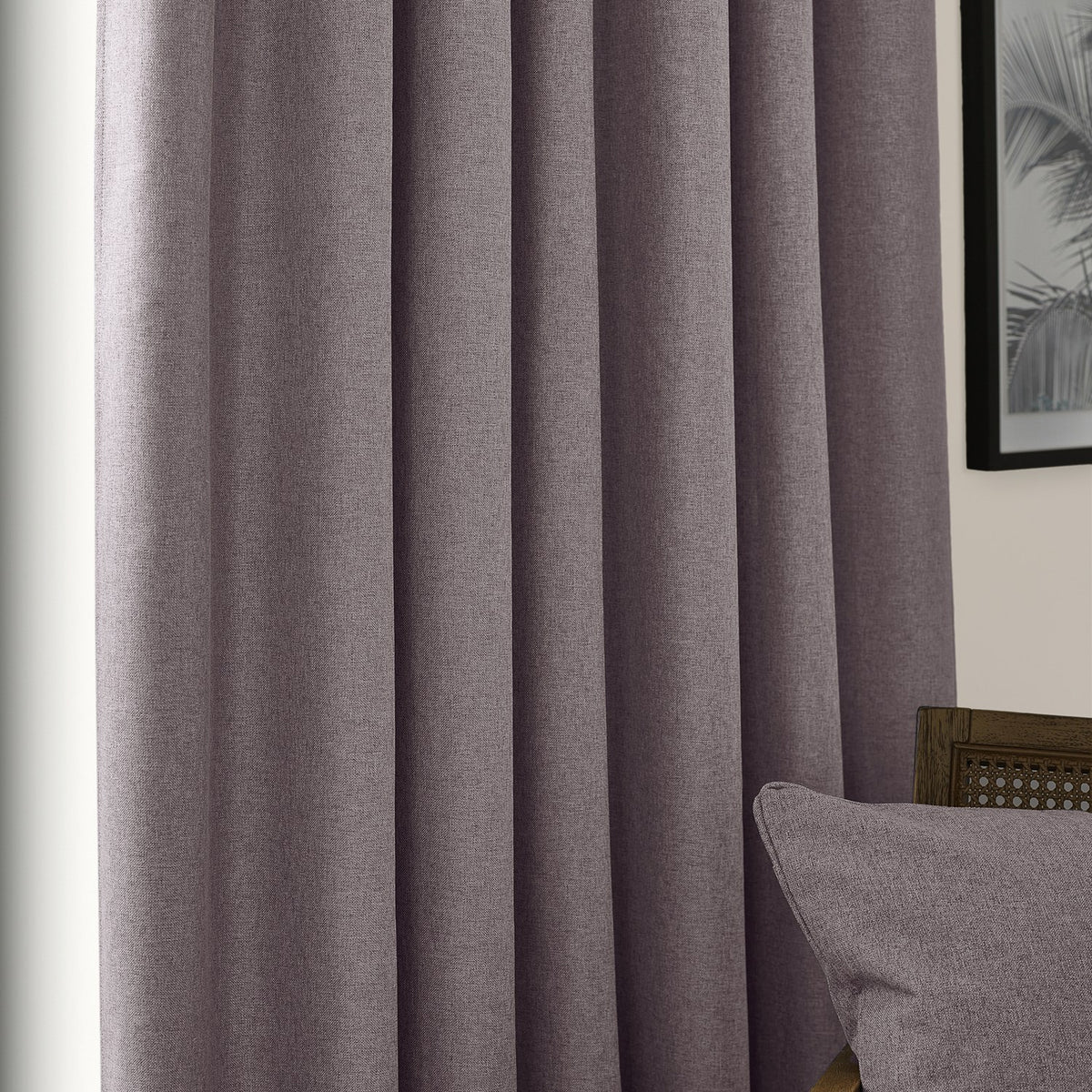 Dawn pencil pleat curtains in charcoal grey, textured polyester fabric with pencil pleat heading, shown hanging in soft folds beside a cushion and framed artwork.