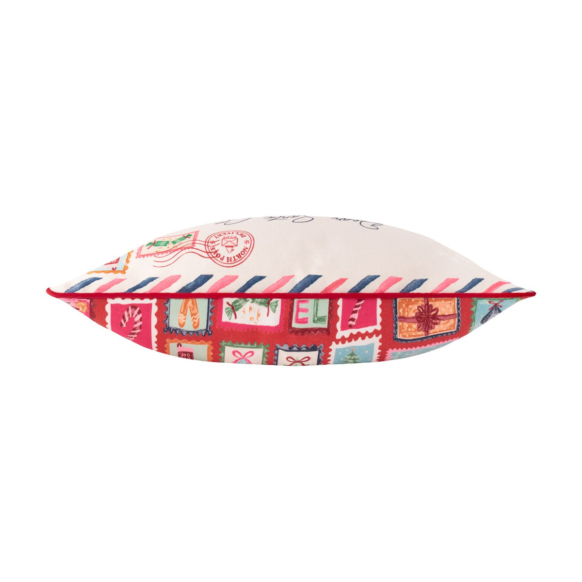 Side view of the Dear Santa Velvet Cotton Cushion, showing cream airmail-style top with red-pink-navy stripes and a red base panel with colourful stamp motifs, on a white background.
