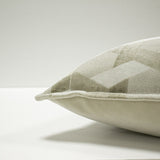Close-up of the Delano Jacquard Velvet Cushion in ivory/taupe, showing the raised lattice pattern with velvet and woven facets and a corner piped edge, on a plain white background.