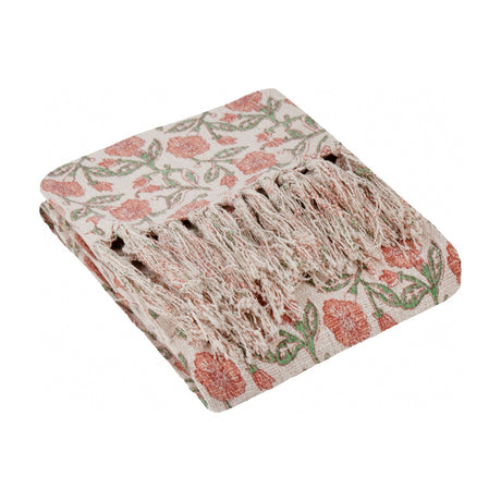 Delphine Floral Cotton Throw in coral, folded to show a block-print floral pattern in coral and green on cream cotton with knotted fringe edging, on a white background.