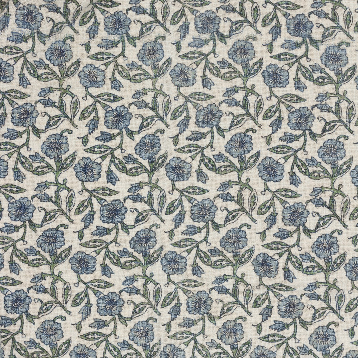 Delphine Floral Cotton Throw in Delph Blue, showing an all-over scattered floral pattern in dusty blue and green on a cream cotton ground with a loosely woven texture.