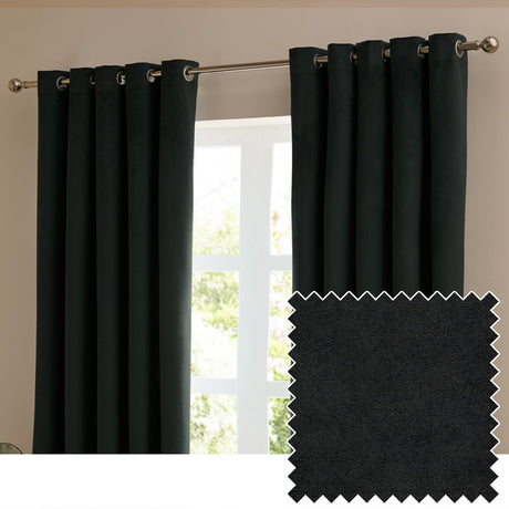 Black velvet eyelet curtains hung on a brushed metal pole beside a window, shown with a fabric swatch highlighting the soft matt pile texture.