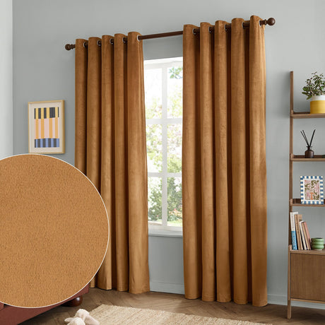 Caramel velvet eyelet curtains with brown grommet rings hanging full-length either side of a window in a light grey living room, inset swatch showing the plain matte pile texture.
