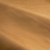 Close-up of caramel gold velvet fabric from The Ultimate Velvet Plain Fully Lined Eyelet Curtains, showing soft matte pile with gentle folds and light-catching sheen.