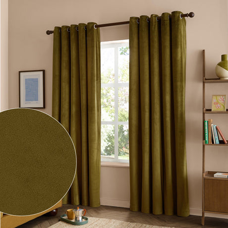 Olive green velvet eyelet curtains with grommet top hang fully lined either side of a window, shown in a living room with a wooden shelf and framed art, alongside a fabric texture swatch.