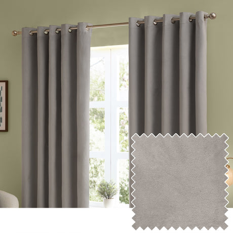Silver-grey velvet eyelet curtains hung on a metal pole in a living room with green walls, shown with a fabric swatch sample of the matte pile.