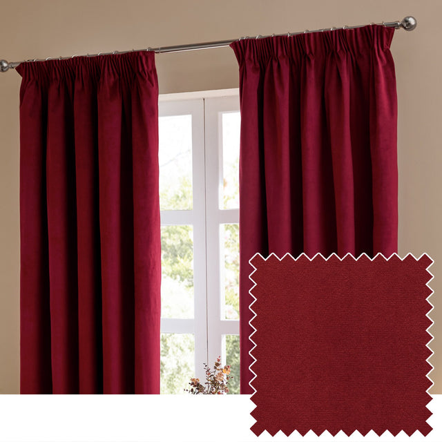 Burgundy velvet pencil pleat curtains with pinch-pleat heading hung on a chrome pole beside a window, shown with a matching fabric swatch corner.