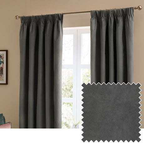Charcoal grey velvet pencil pleat curtains hanging from a metal pole in a living room window, shown with a matching fabric swatch inset.