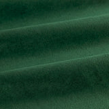 Close-up of The Ultimate Velvet Pencil Pleat Curtains in emerald green, showing soft folds in 100% polyester velvet with light and dark shading across the fabric.