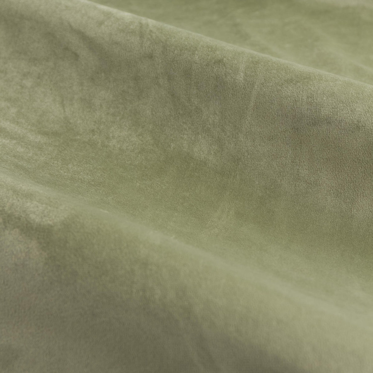 Close-up of The Ultimate Velvet Pencil Pleat Curtains in green, showing soft matt velvet pile with visible folds and a subtle sheen.