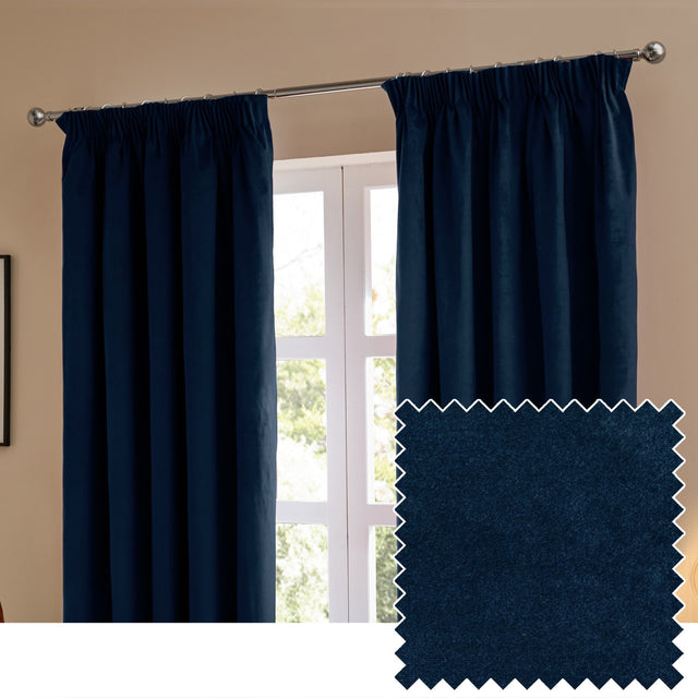 Royal blue velvet pencil pleat curtains with tape header hung on a chrome pole beside a window, shown with a fabric swatch sample.