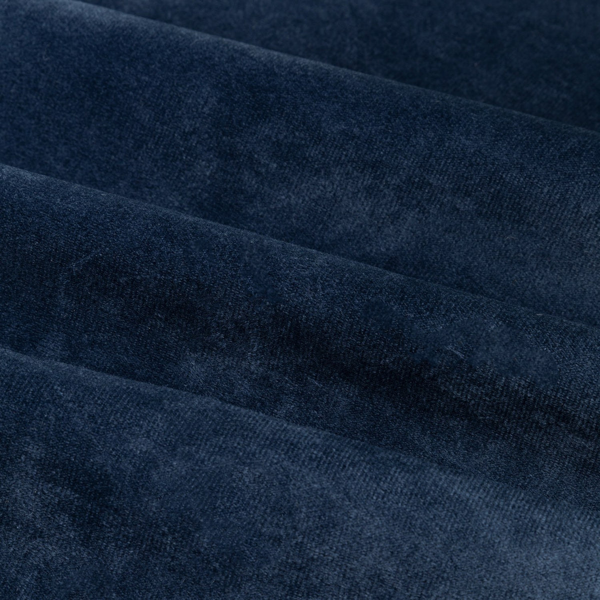 Close-up of The Ultimate Velvet pencil pleat curtain fabric in royal blue, showing soft matte velvet pile with folds creating varying tonal depths.