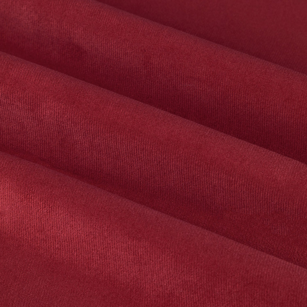 Close-up of The Ultimate Velvet Plain Lined Eyelet Curtains in burgundy, showing soft matt velvet fabric with folds catching gentle light.