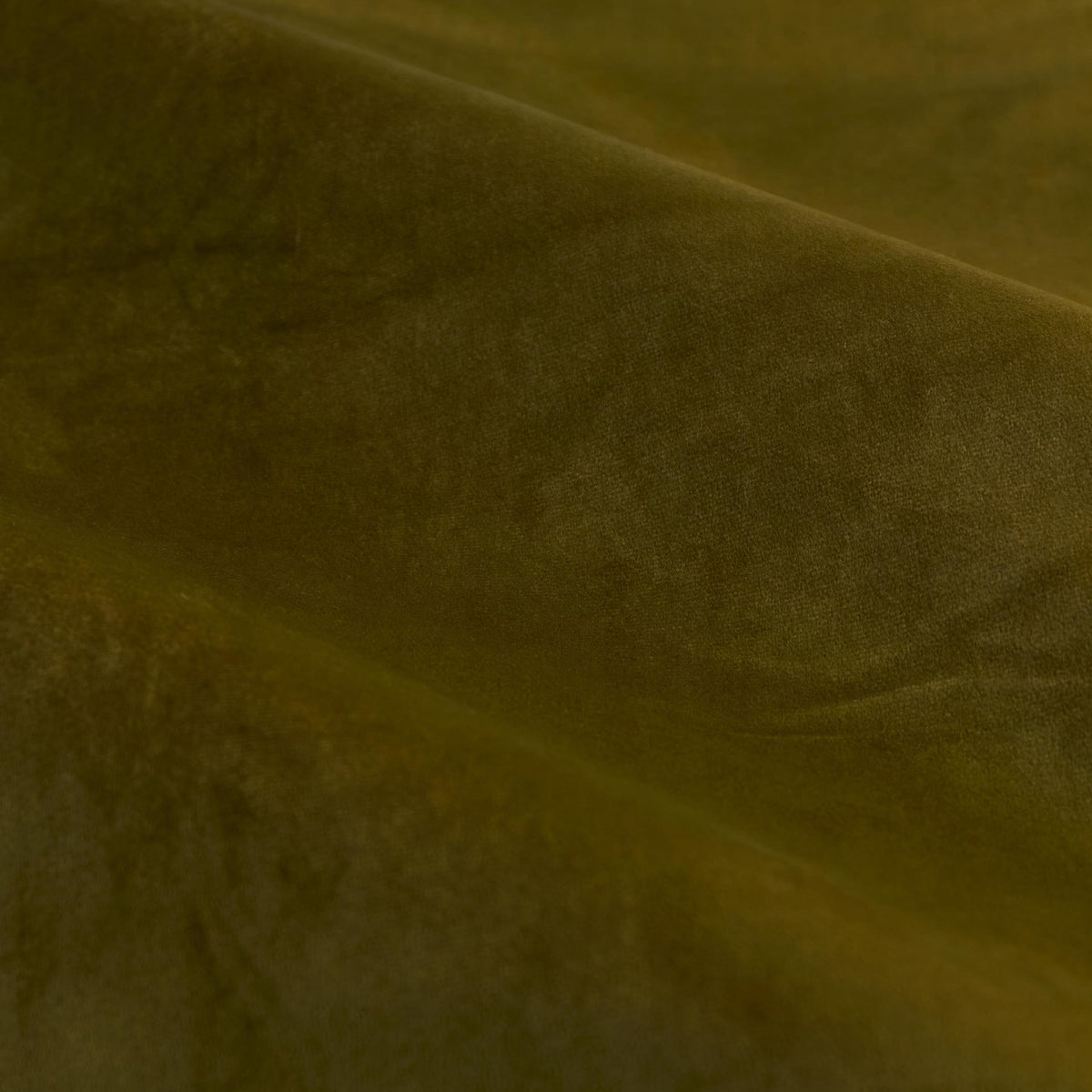 Close-up of The Ultimate Velvet Plain Lined Eyelet Curtains in olive, showing the soft matt velvet pile and fluid draped folds catching light across the fabric.