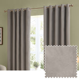 Silver velvet eyelet curtains hung on a bronze pole in a green-walled room, shown as a pair beside a matching plain fabric swatch.